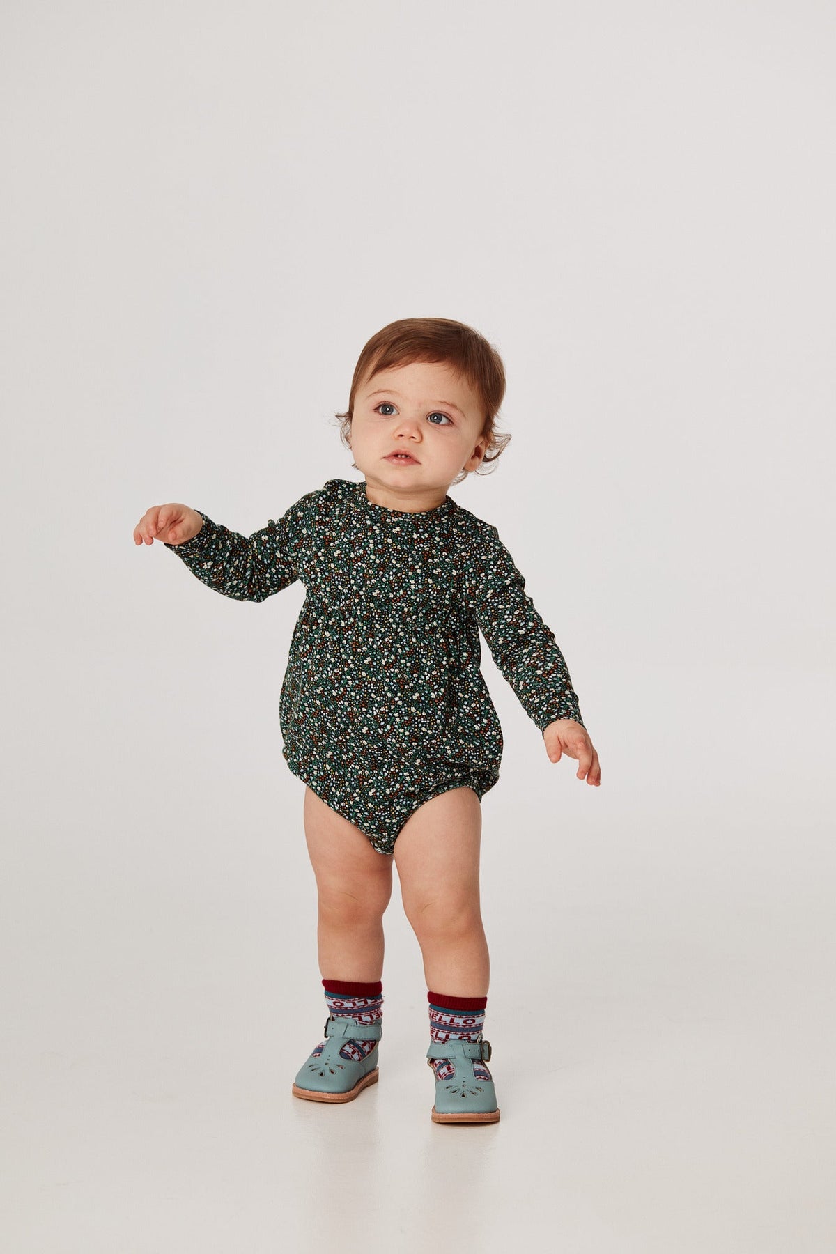 Balloon Romper - Emerald Mini Floral+Model is 31 inches tall, 23lbs, wearing a size 12-18m