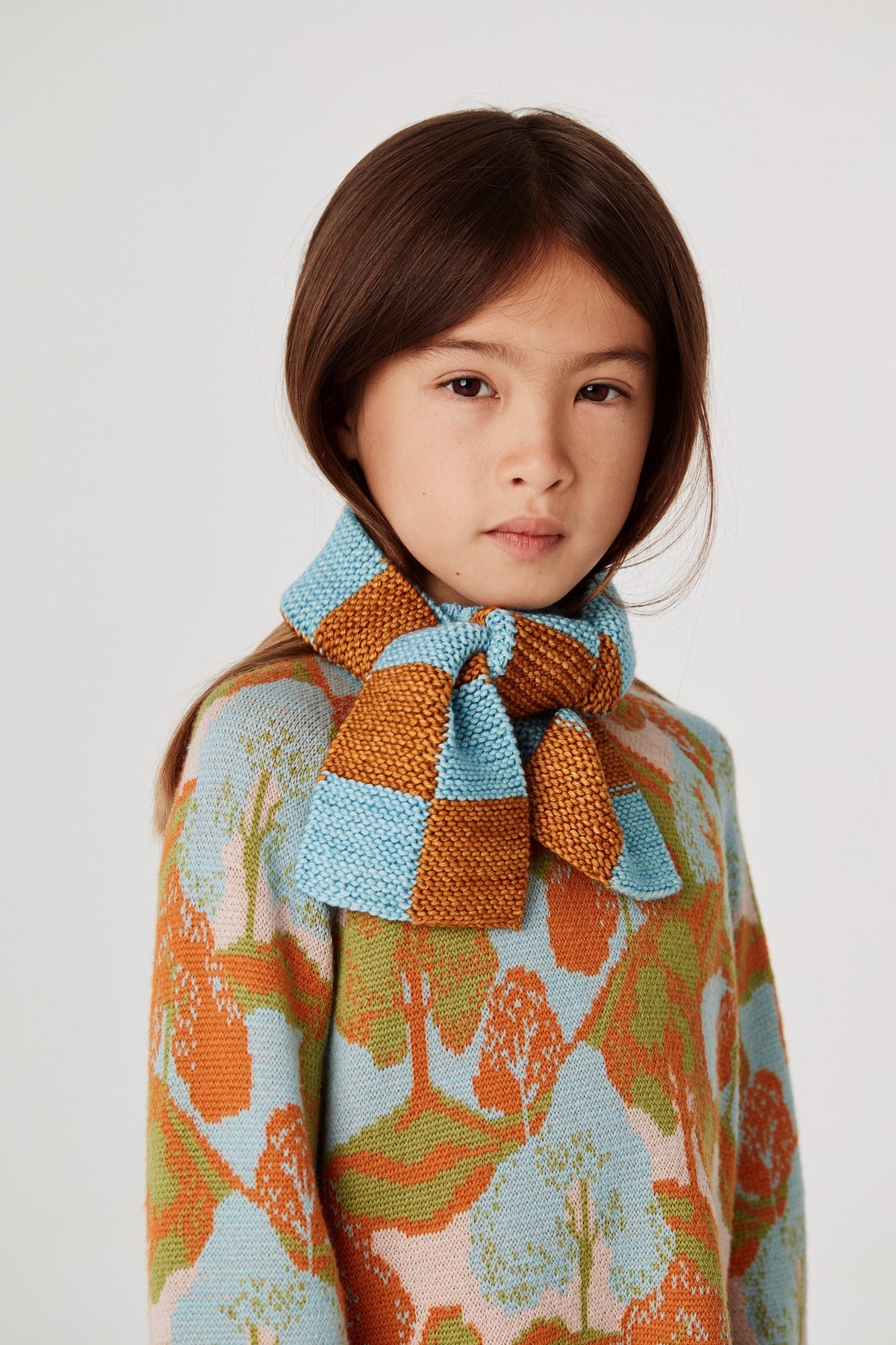 Checkerboard Scarf - Marigold+Model is 48 inches tall, 47lbs, wearing a size One Size