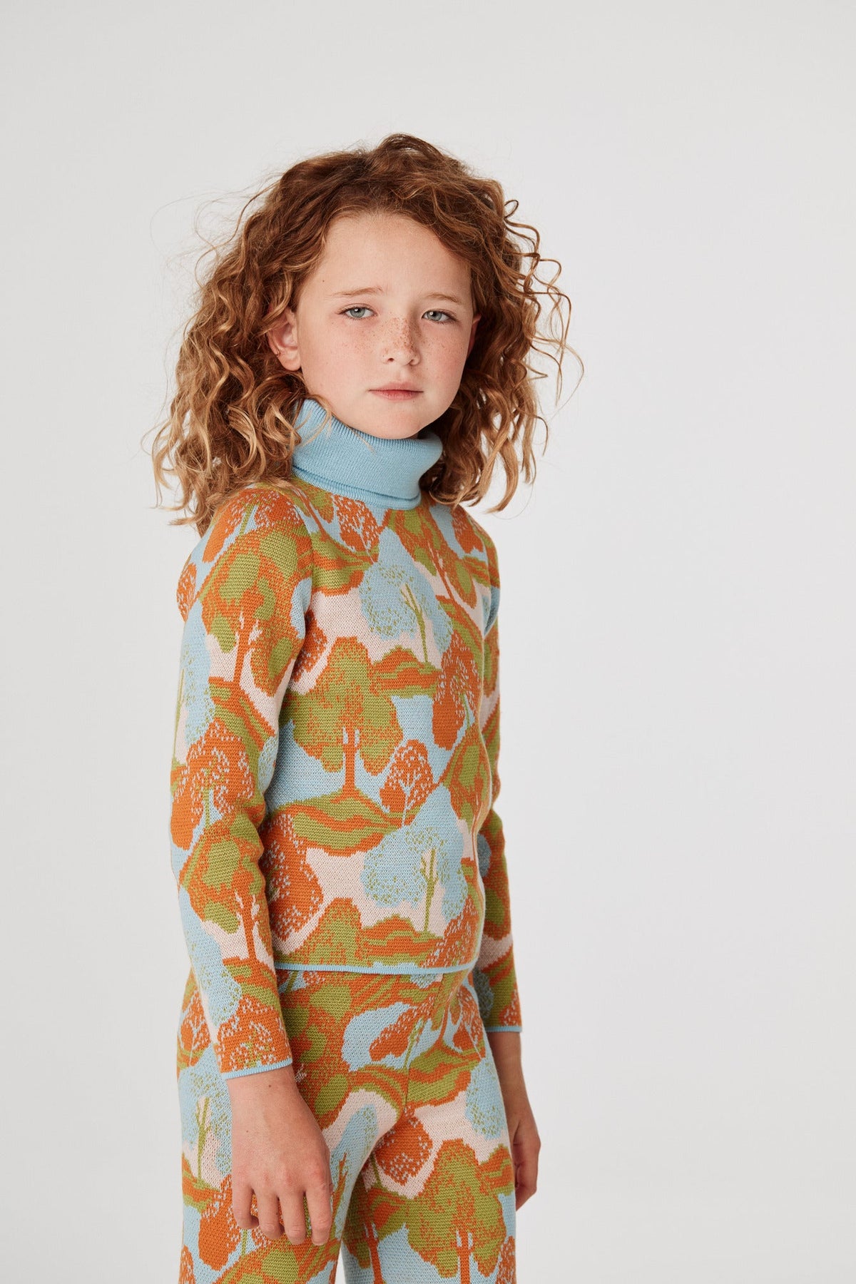 Jacquard Turtleneck - Dune Landscape+Model is 53 inches tall, 58lbs, wearing a size 7-8y