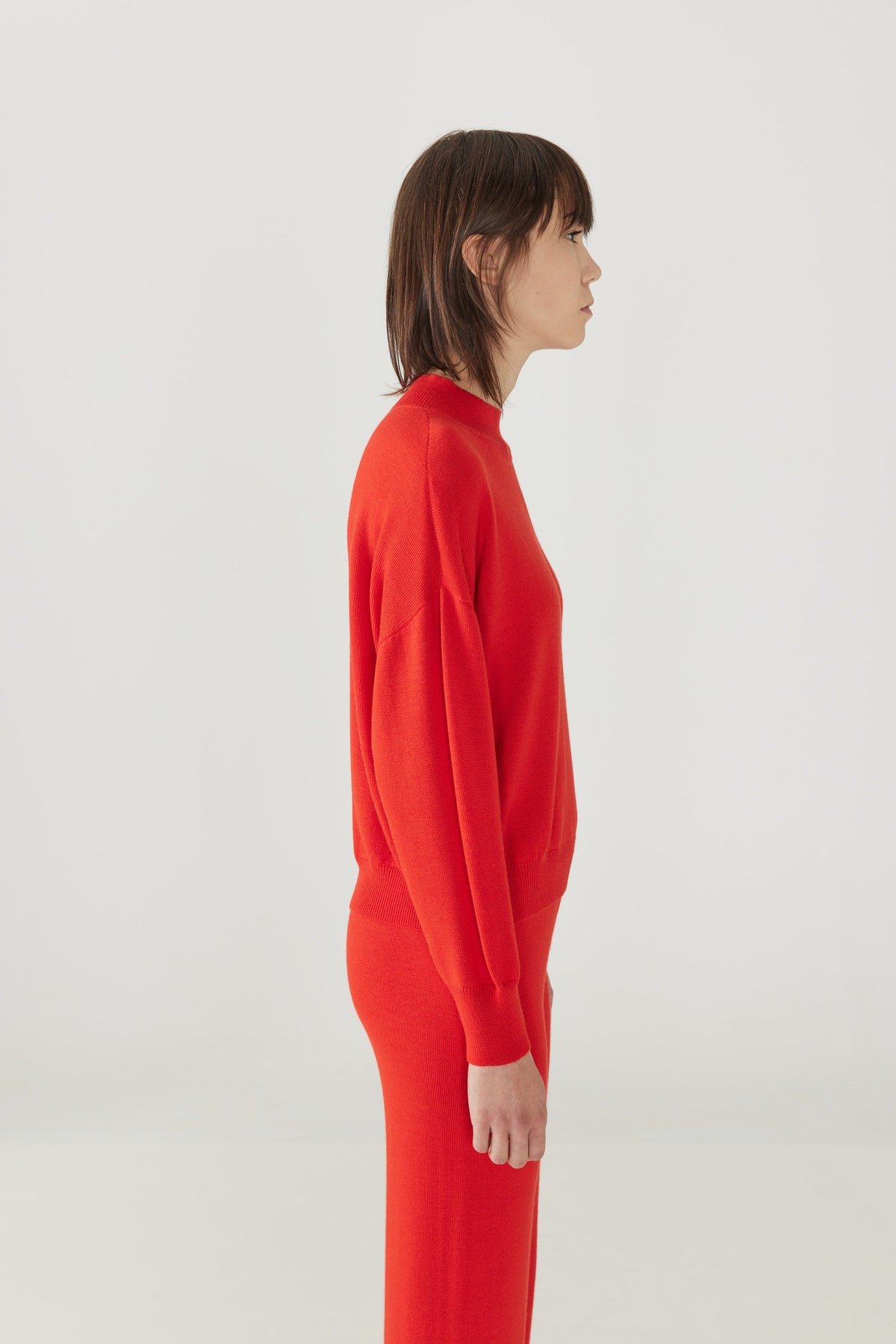 Adult Merino Mock Neck Pullover - Red Flame+Model is 6&#39;&quot; | 32&quot; Bust | 25&quot; Waist | 36.75&quot; Hips | size 2, wearing a size Small