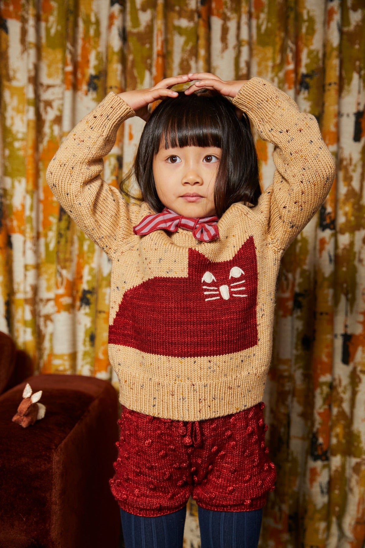 Cat Sweater - Camel Confetti+Model is 43 inches tall, 38lbs, wearing a size 4-5y