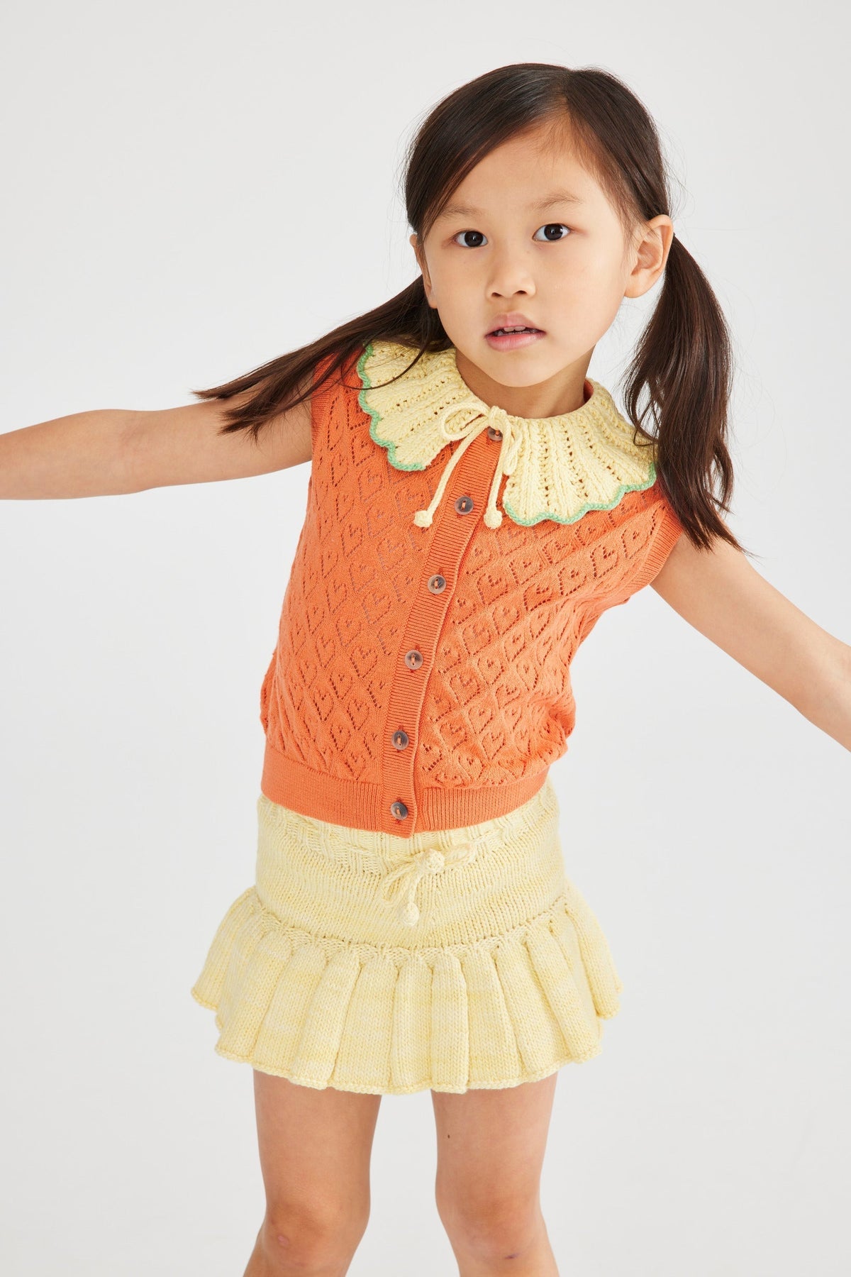 Hearts Eyelet Zoe Vest+Model is 43 inches tall, 45lbs, wearing a size  4-5y