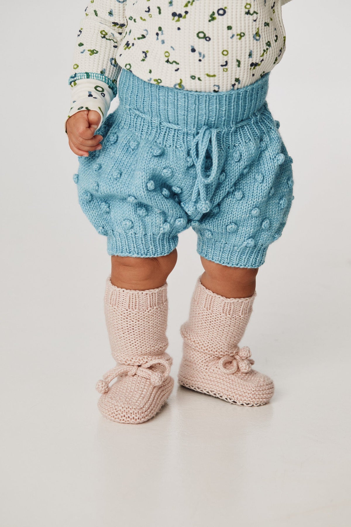 Popcorn Bloomer - Faded Denim+Model is 19 inches tall, 27lbs, wearing a size 12-18m