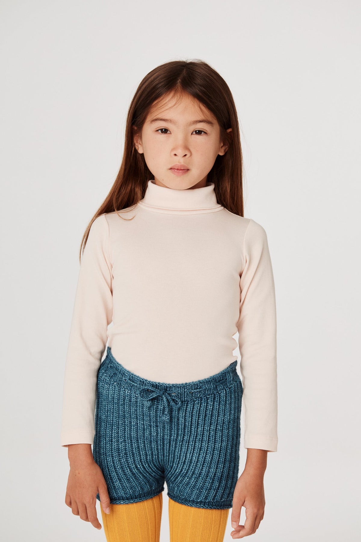 Turtleneck - Dune+Model is 48 inches tall, 47lbs, wearing a size 4-5y